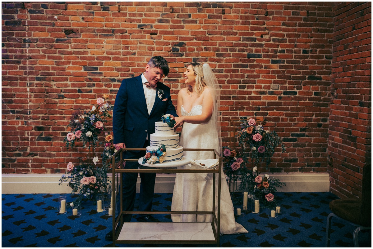 bride and groom cut the cake