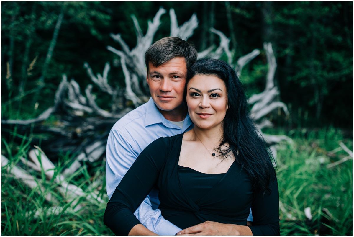 couple sitting on fallen tree