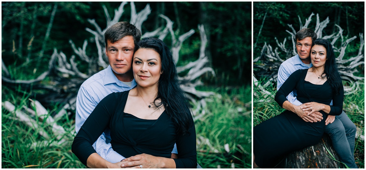 man and woman sitting on tree roots