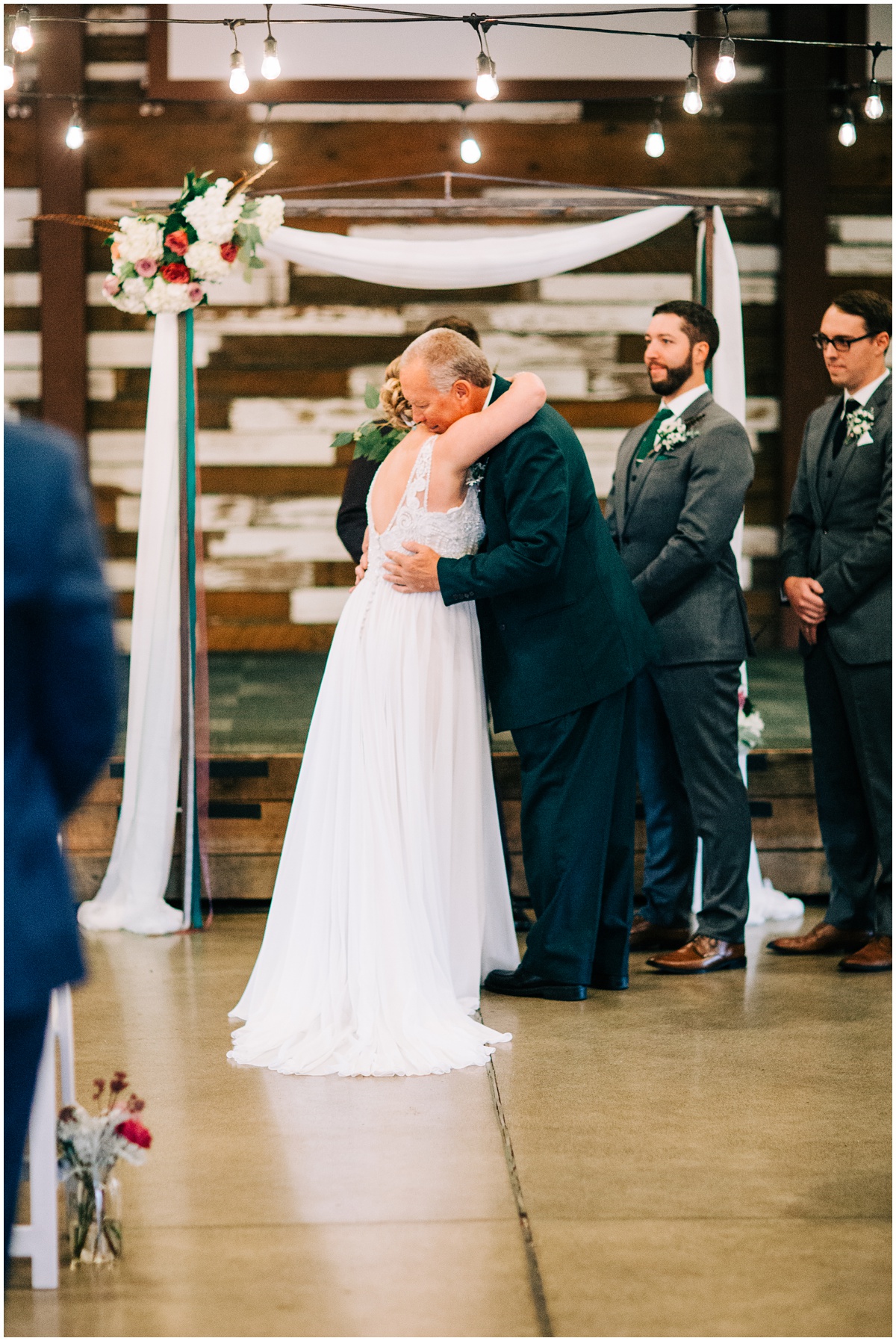 bride hugs father at altar