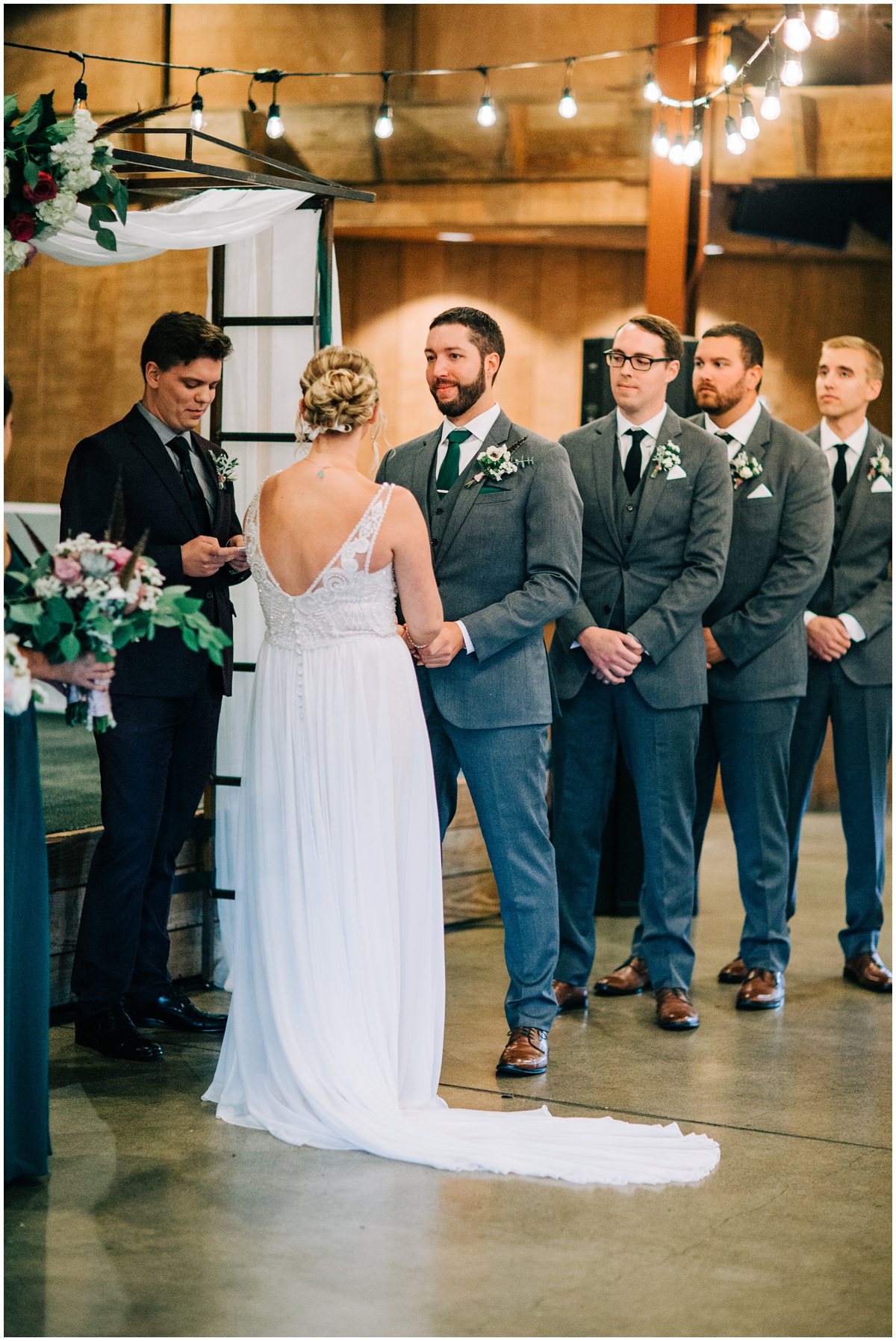 bride and groom hold hands during ceremony