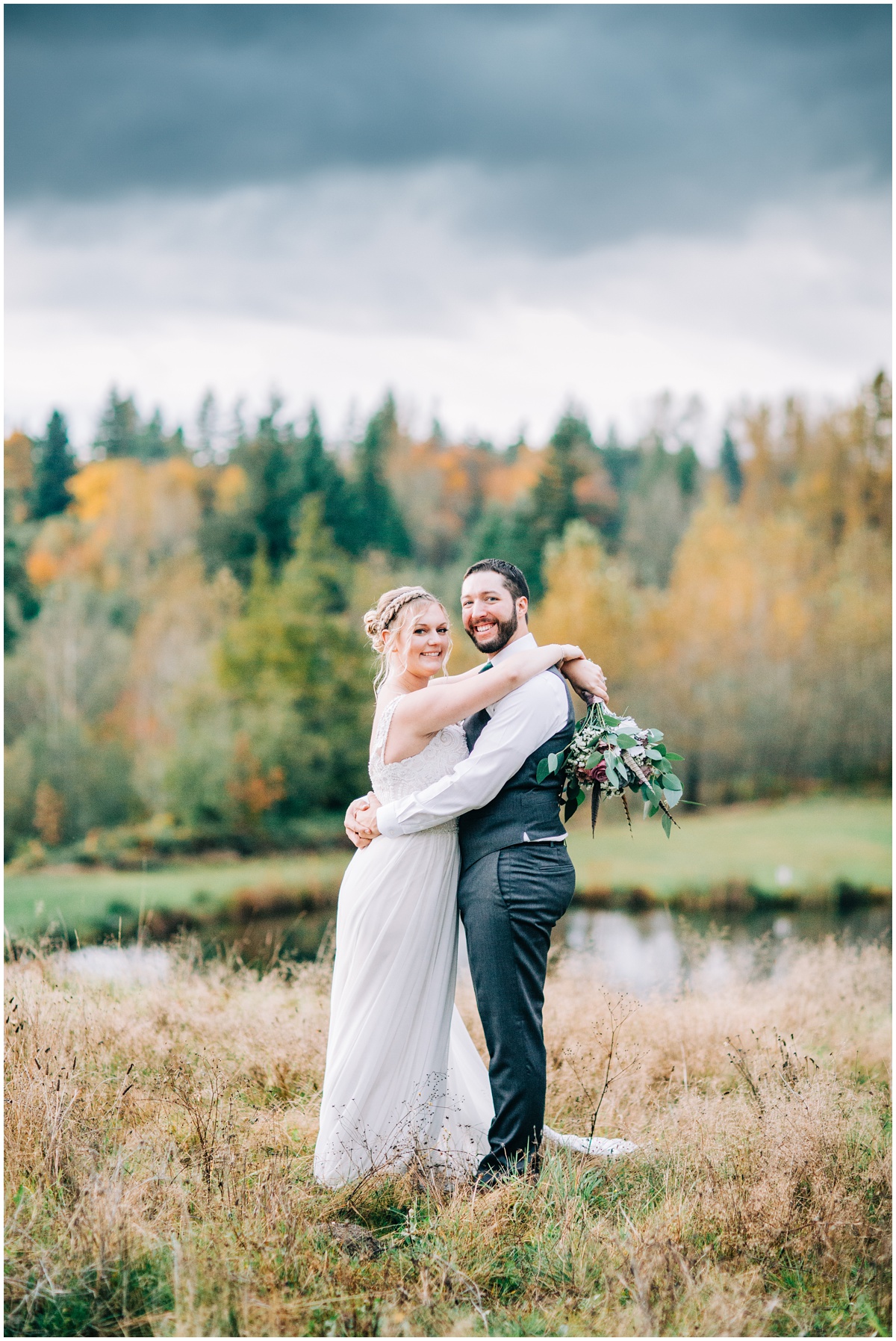 bride and groom embrace and look at camera