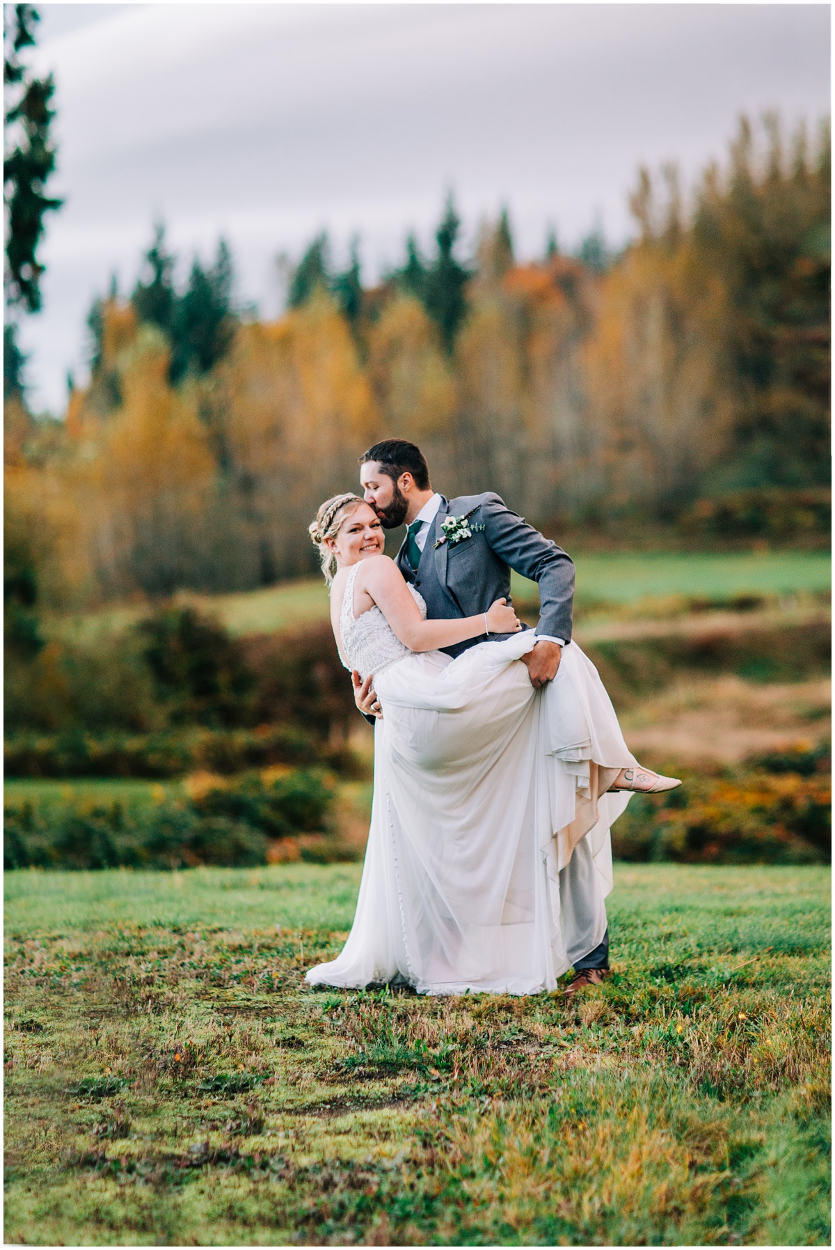 groom dips bride in photo