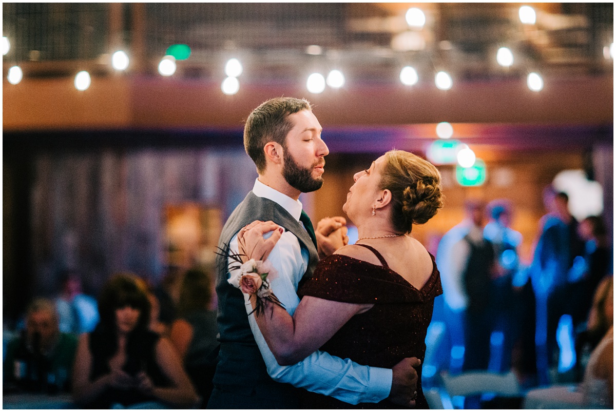 groom and mother dancing and singing