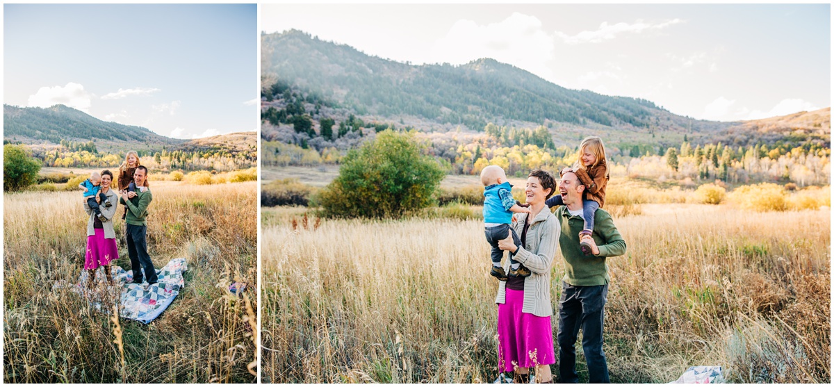 parents holding kids in the fiield