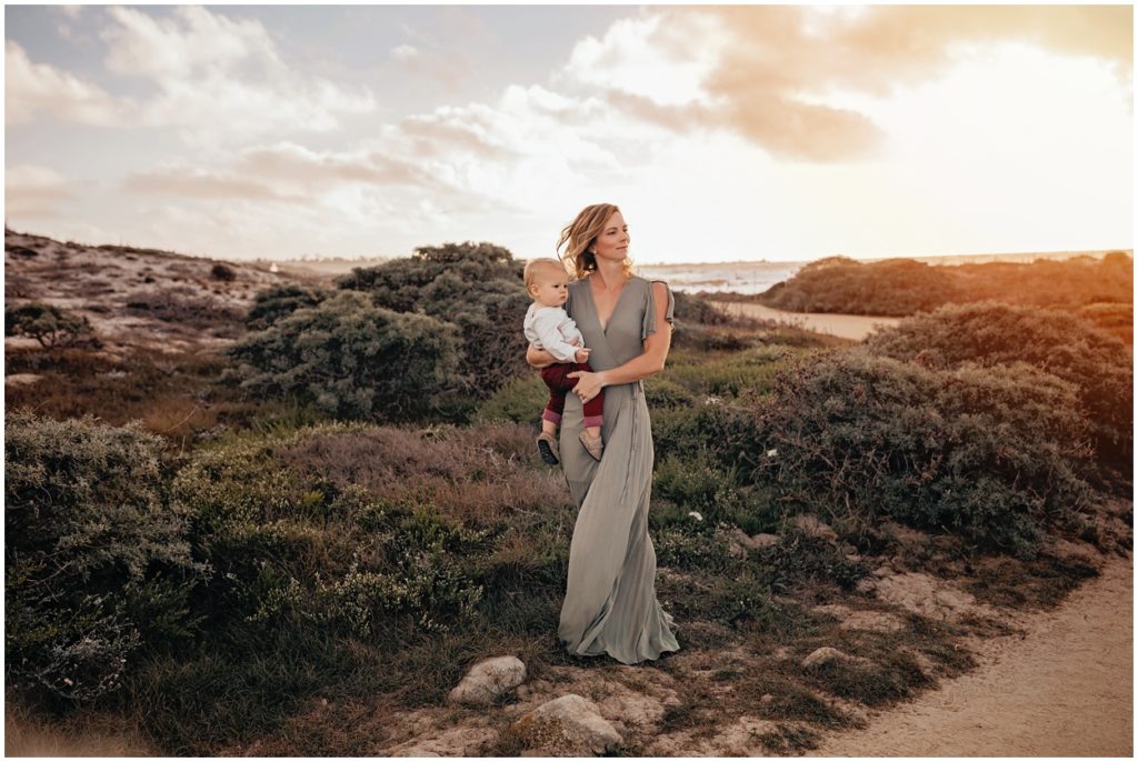 mother holding her son in the wind at asilomar beach