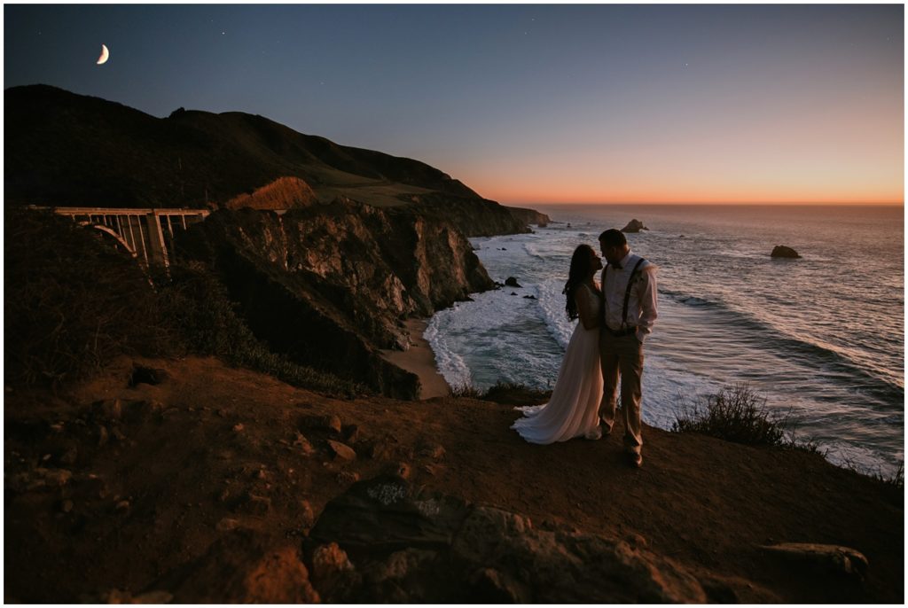 bride and groom by bixby bridge on highway 1 california