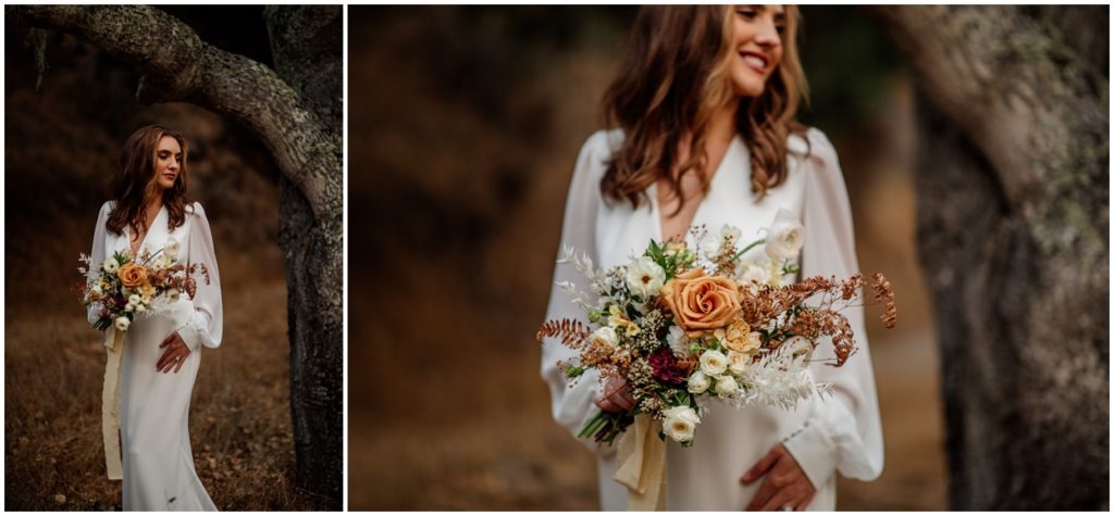 bride standing by tree holding bridal bouquet