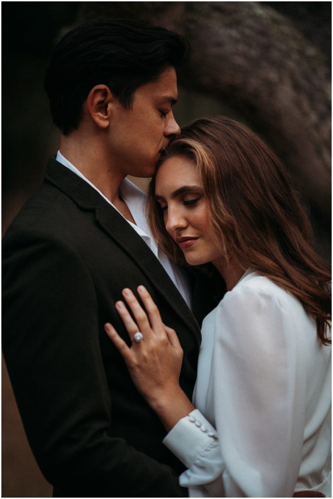 bride standing by groom with her hand on his chest showing wedding ring