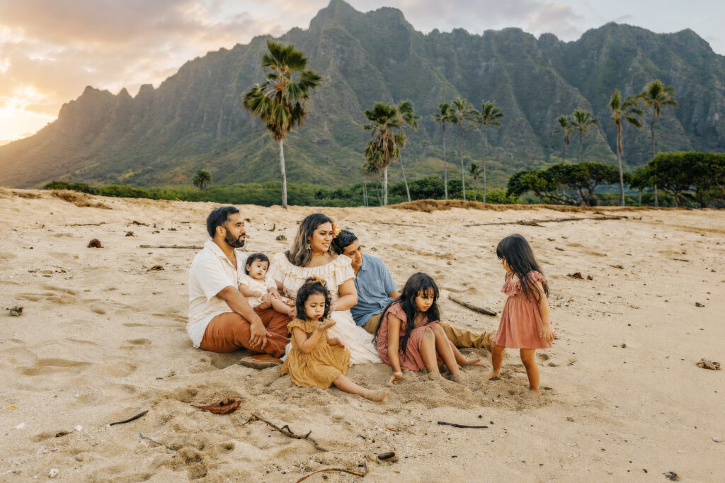 family wearing warm color palate at the beach dusty blue, mustard, terracotta, rose, and rust